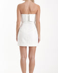 White strapless dress worn by a model on a white background