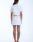 Woman wearing a white outfit on a white background