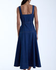 Woman wearing a beautiful denim dress on a white background