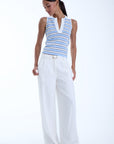 Model wearing a beautiful tank top with long pants on a white background