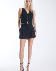 Agus set in black, sleeveless waistcoat with gold buttons worn with high waisted tailored shorts and a studded belt, front view on model.