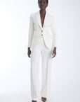 Agus cropped blazer in ecru with a notched lapel, worn with matching wide leg trousers, front view on model.