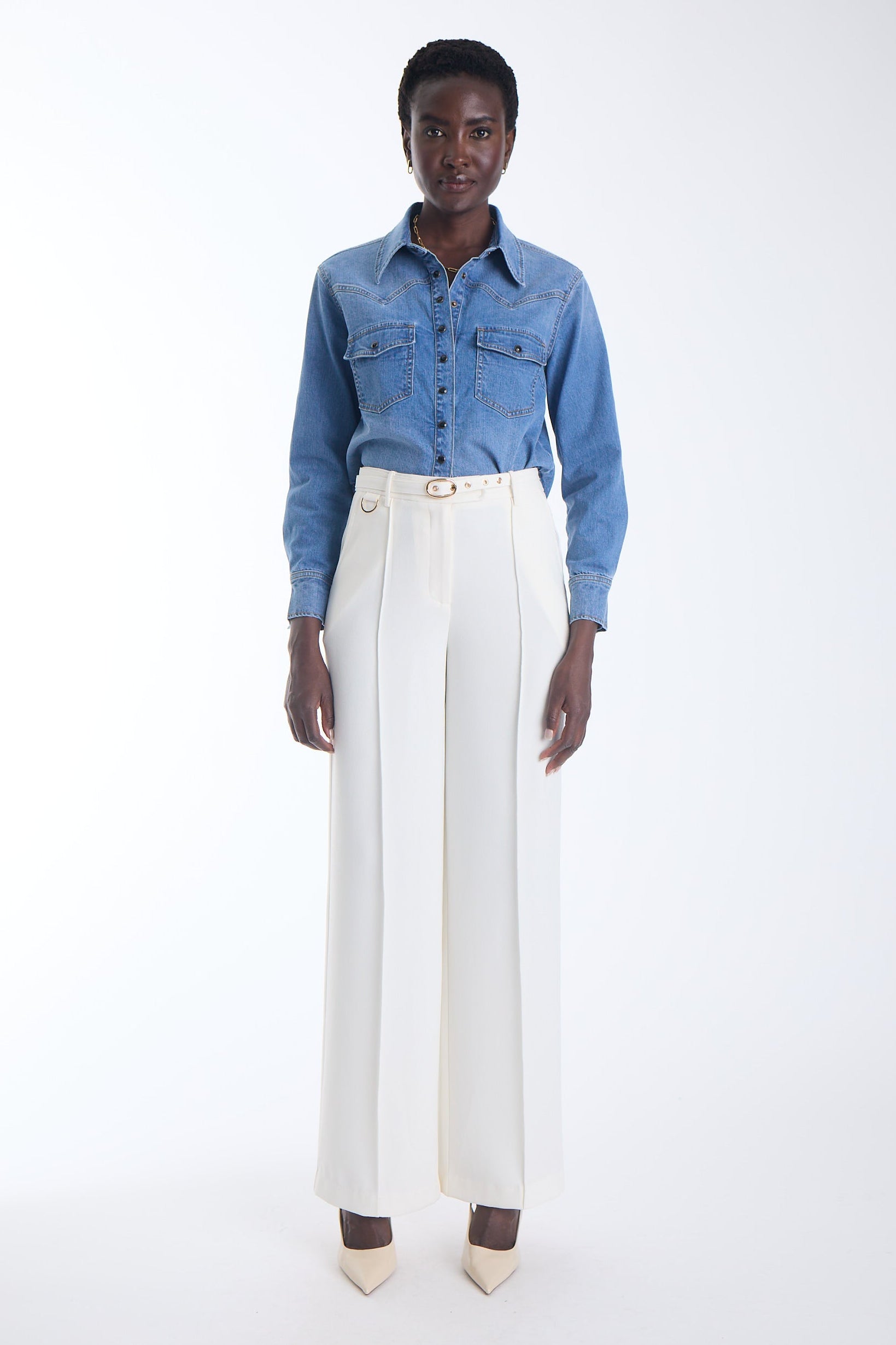 Alex high waisted wide leg trousers in ecru with a gold buckle self belt and pressed crease, front view on model.