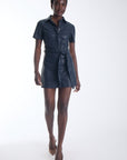 Mallie vegan leather mini shirtdress in navy with a self tie belt, front view on model.