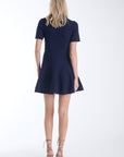 Elsa knit mini dress in navy, back view on model.