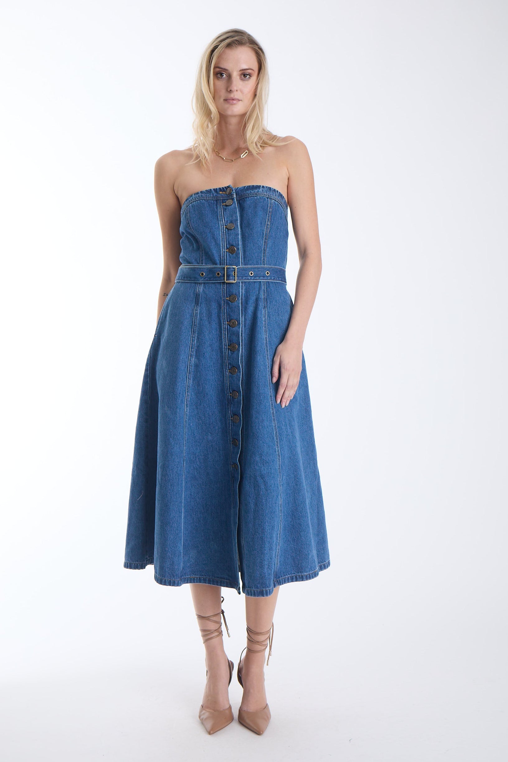 Mica strapless denim midi dress with antique gold buttons and a belted waist, front view on model.