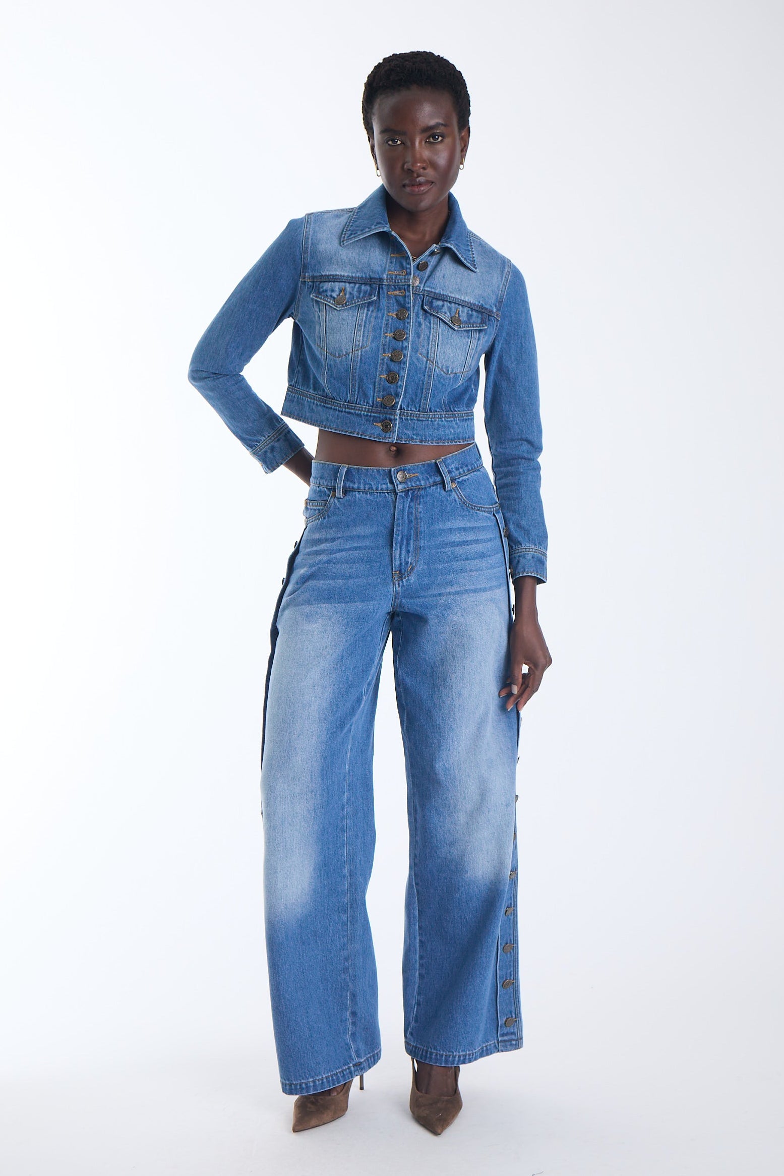 Mica cropped denim jacket with antique gold buttons and flap chest pockets, front view on model.