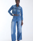 Mica cropped denim jacket with antique gold buttons and flap chest pockets, front view on model.