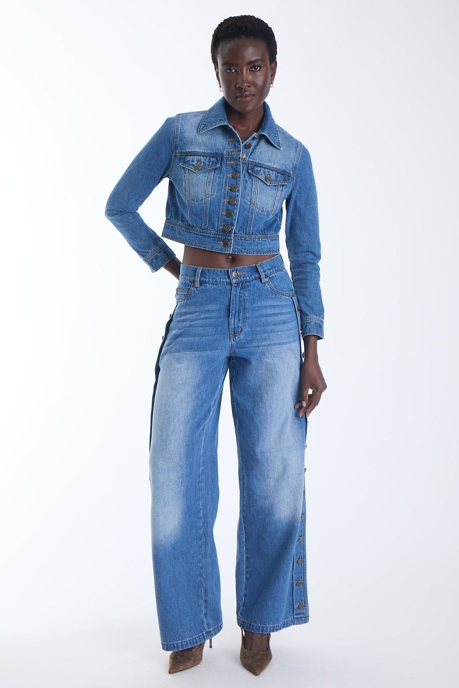 Mica wide leg jeans in denim blue with antique gold buttons down the outside seam, worn with the Mica Denim Jacket, front view on model.