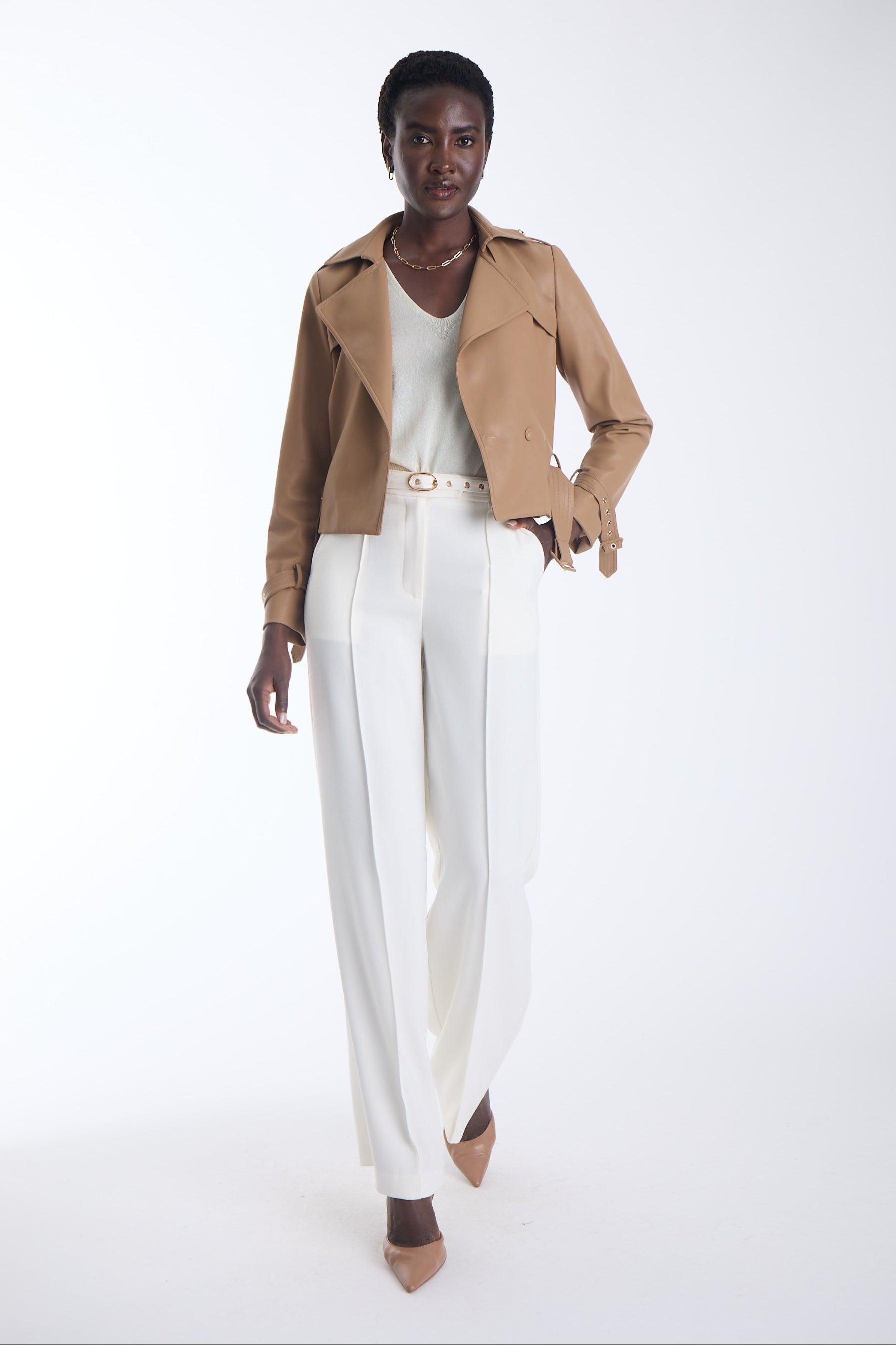 Vida cropped vegan leather trench jacket in camel with a notched lapel and self belt, worn open, front view on model.