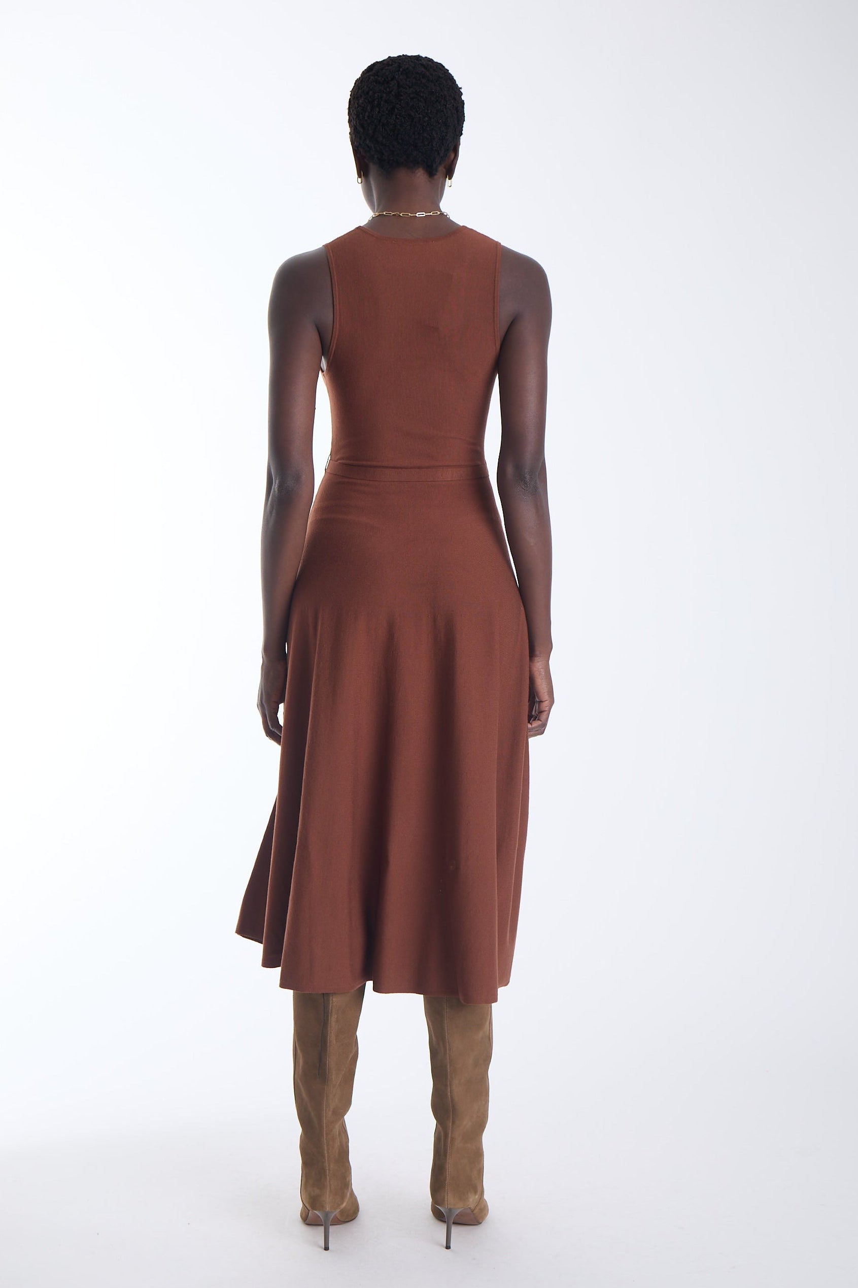 Ariene knit midi dress in copper cedar, back view on model with tan knee high boots.