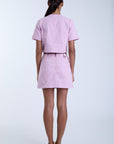 Person wearing a pink outfit on a white background