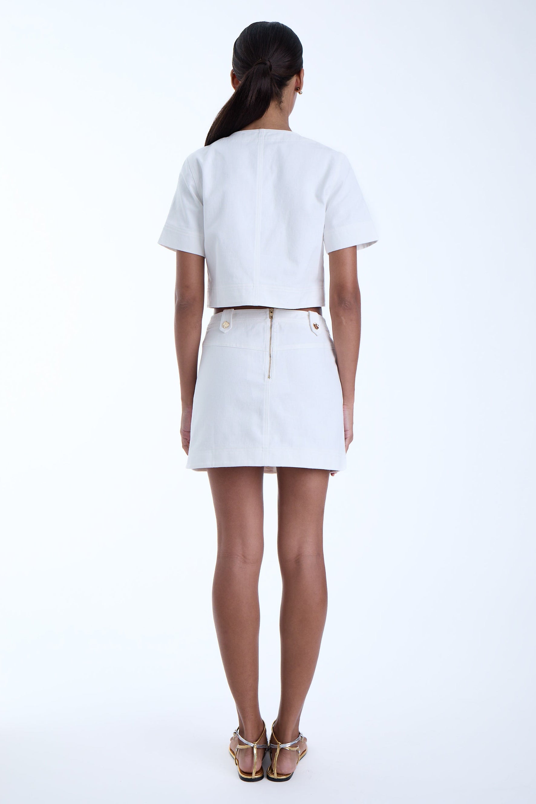 Woman wearing a white outfit on a white background