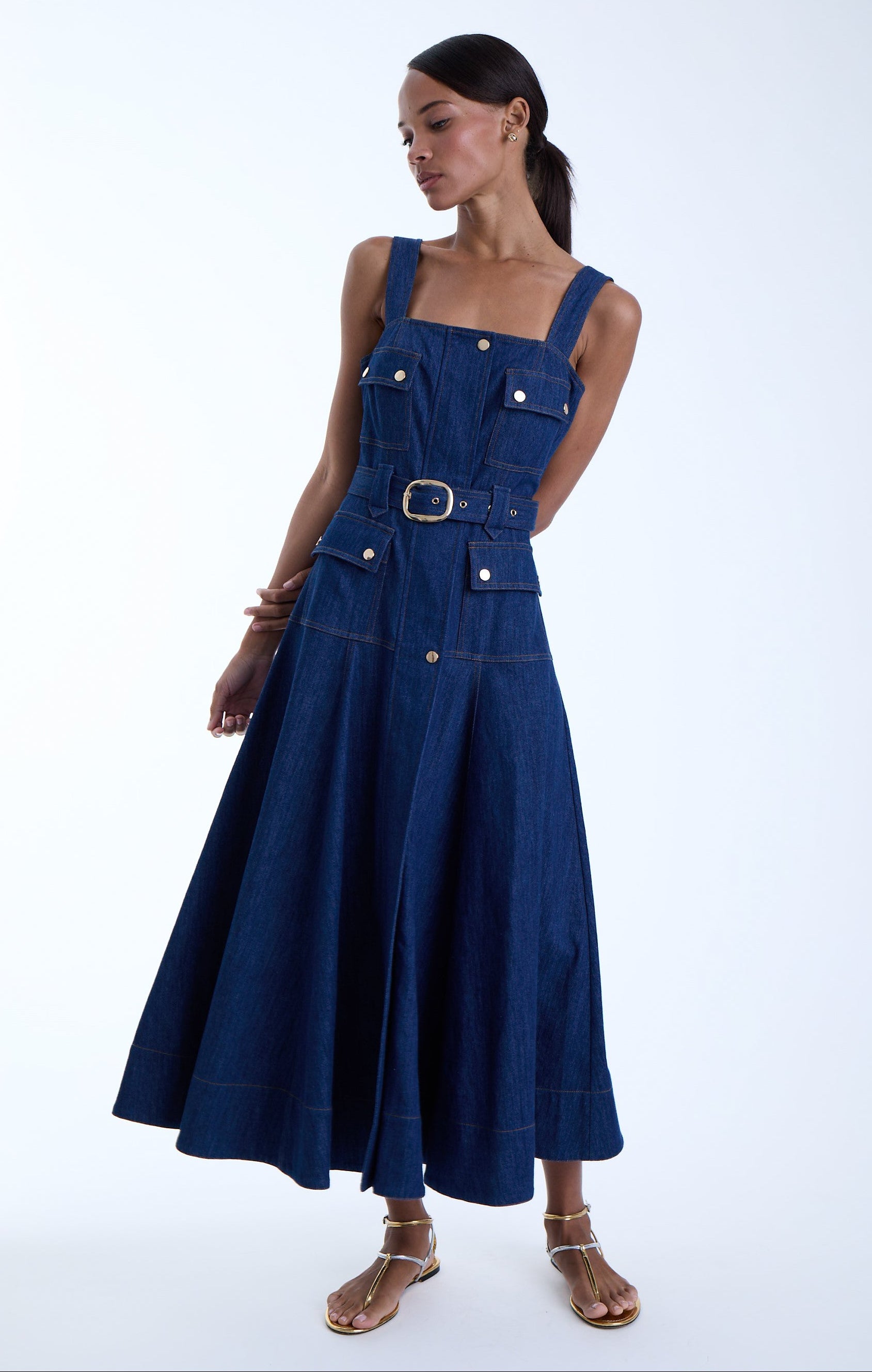 Woman wearing a beautiful denim dress on a white background