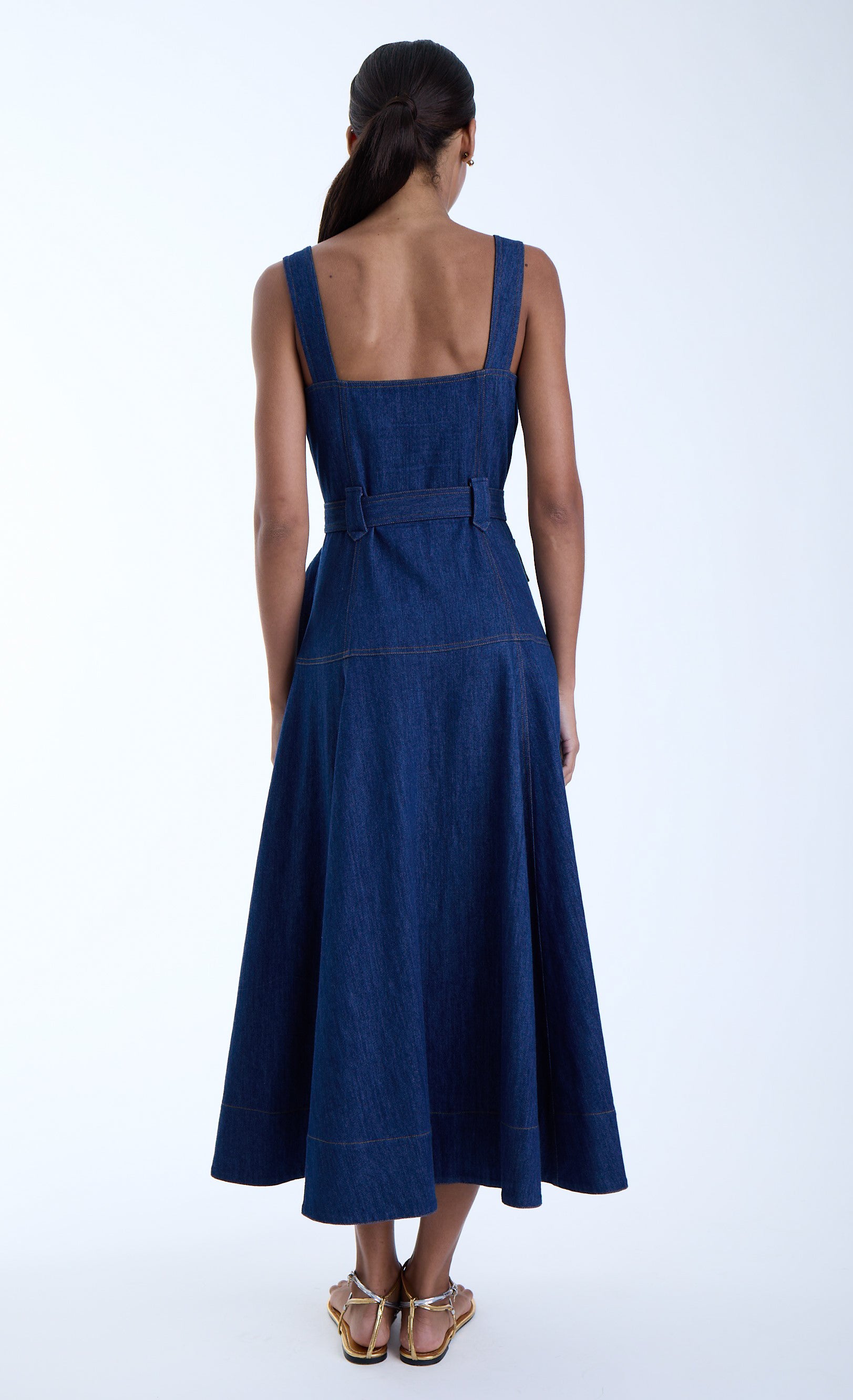 Woman wearing a beautiful denim dress on a white background