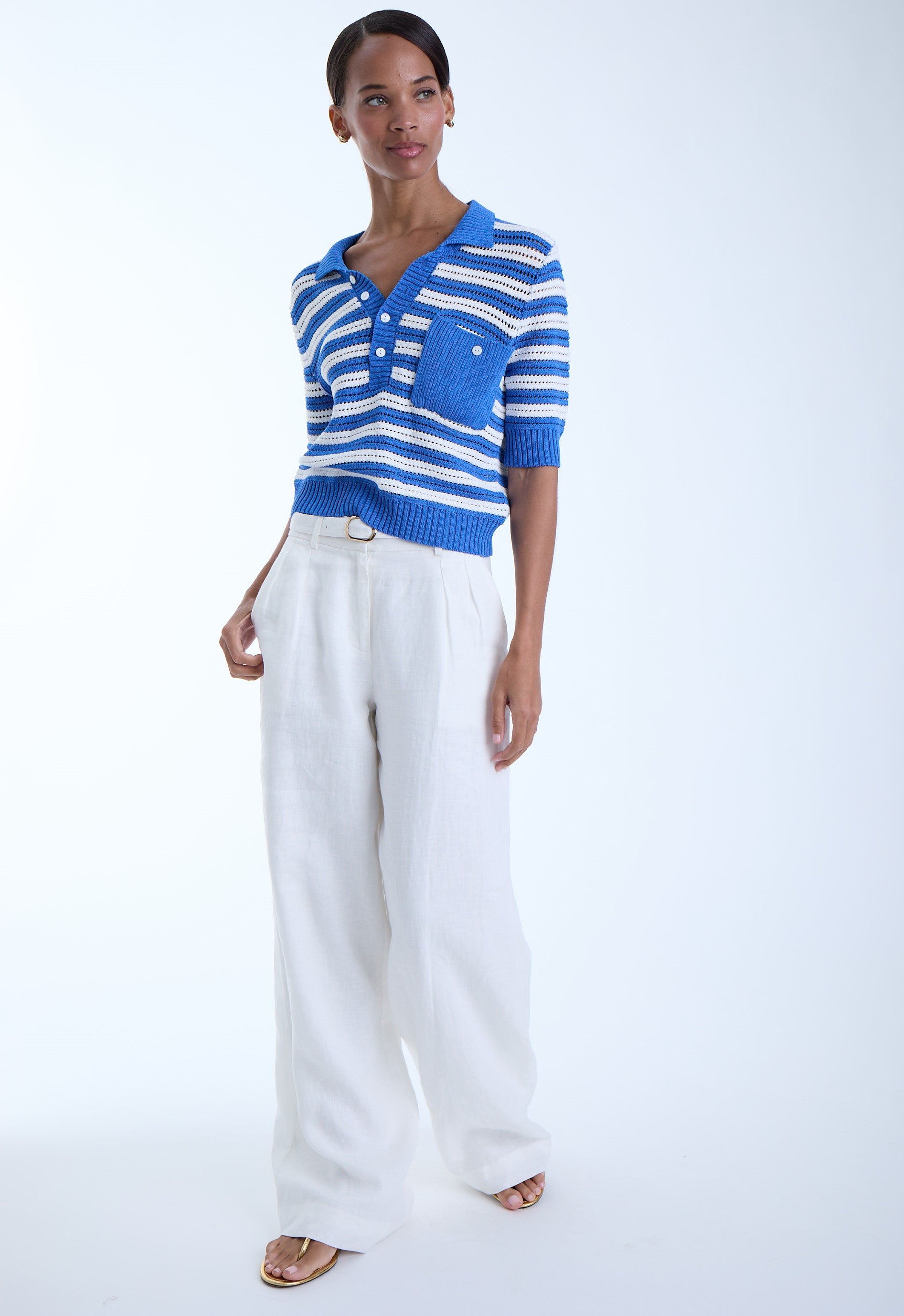 Woman wearing a beautiful blue and white stripped shirt on a white background