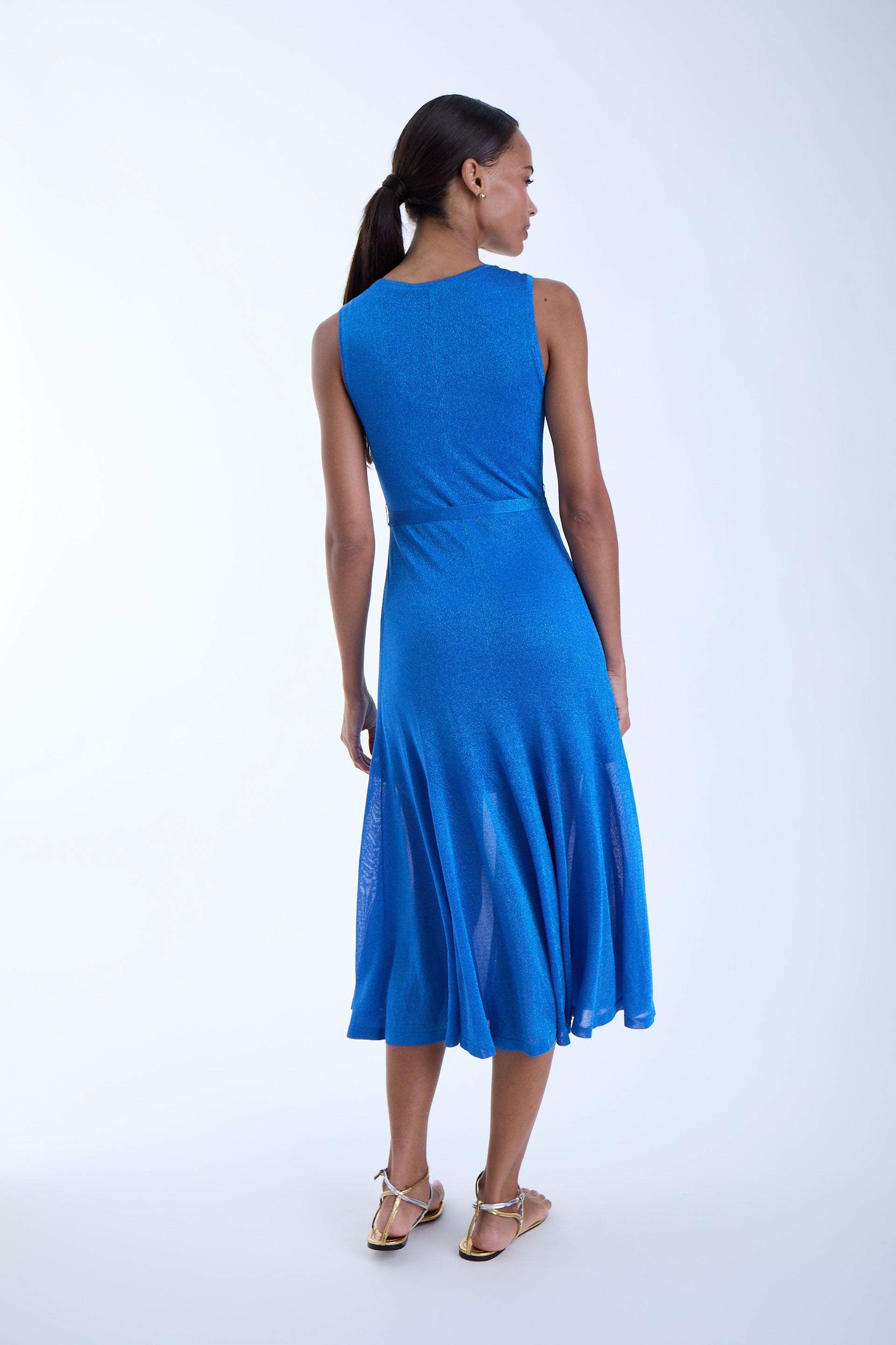Woman wearing a blue dress on a white background