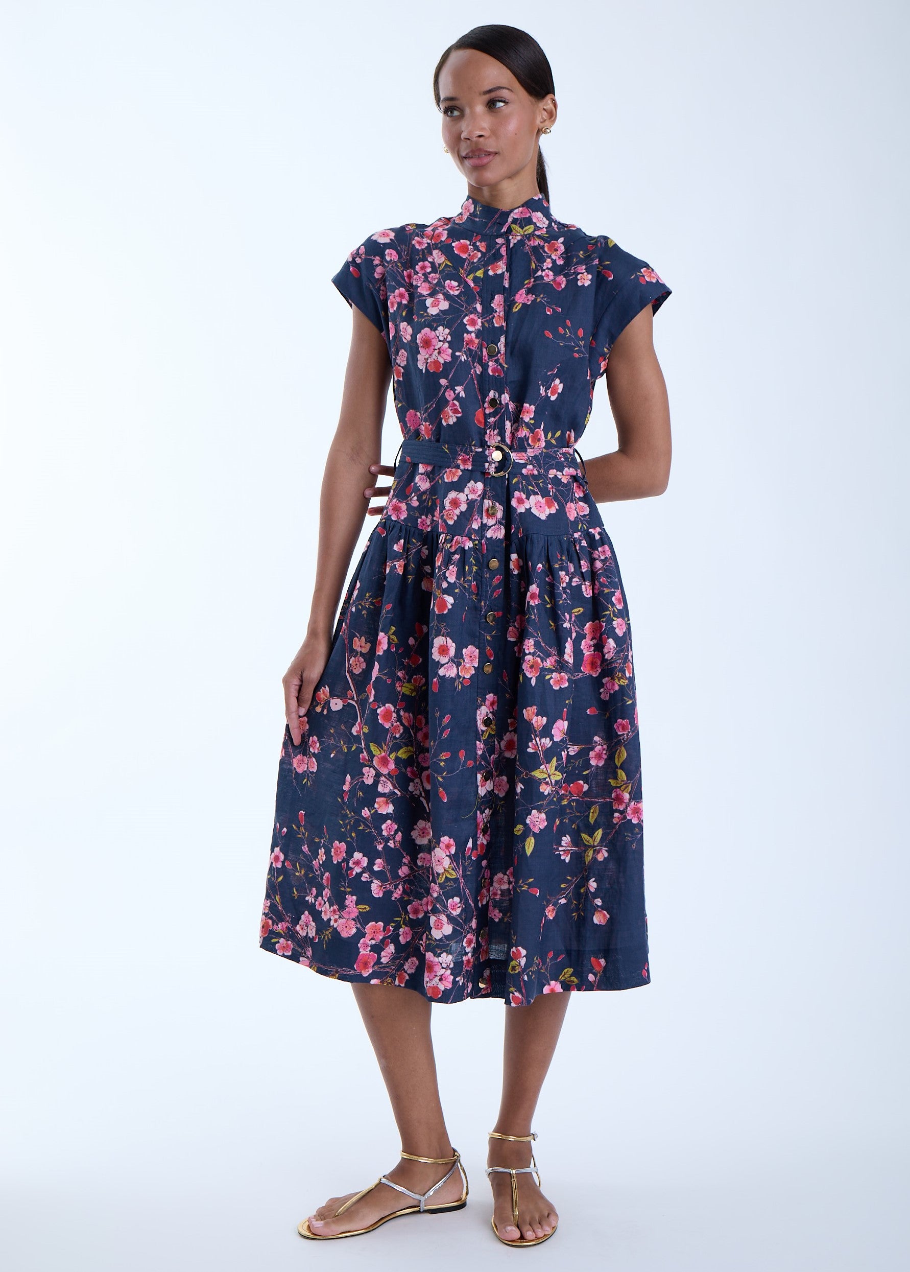 Model wearing a beautiful floral print dress with a white background 
