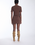 Karina Grimaldi Aria Suede Skirt in chocolate brown, back view on model, mini length with two back pockets