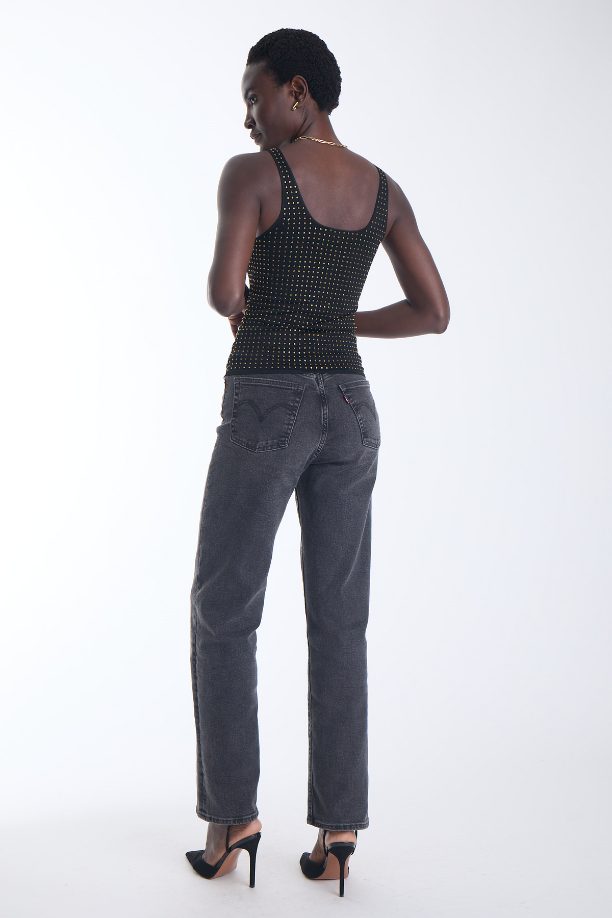 Karina Grimaldi Bowie Embellished Knit Tank in black, back view on model, scoop back with allover gold studs