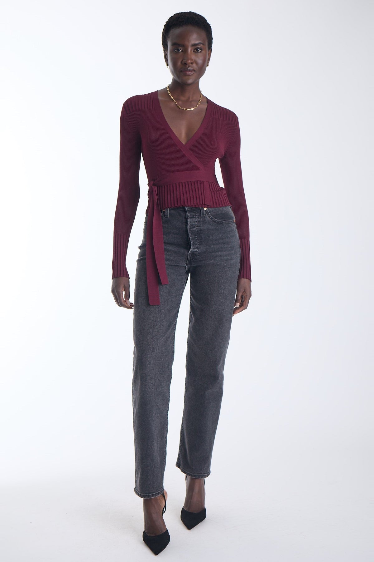 Karina Grimaldi Freya Knit Wrap Top in carbernet, front view on model, ribbed knit with a V neck, long sleeves and a tie waist