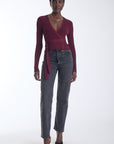 Karina Grimaldi Freya Knit Wrap Top in carbernet, front view on model, ribbed knit with a V neck, long sleeves and a tie waist