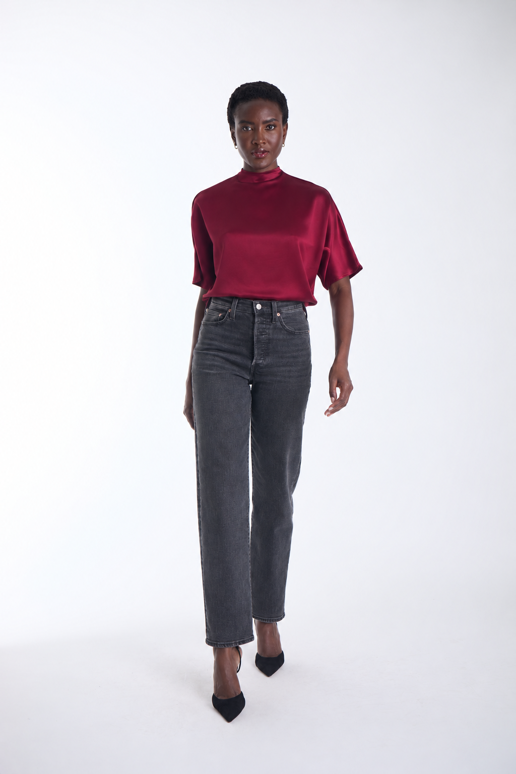 Karina Grimaldi Thea Blouse in mulberry satin, front view on model, high neck with short wide sleeves, worn with jeans