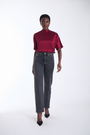 Karina Grimaldi Thea Blouse in mulberry satin, front view on model, high neck with short wide sleeves, worn with jeans