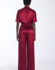 Karina Grimaldi Thea Pants in mulberry satin, back view on model, high waisted and wide leg, worn with the Thea Blouse