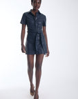 Karina Grimaldi Mallie Vegan Leather Mini Dress in navy, front view on model, pointed collar and short sleeves with a self tie belt at the waist.