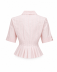 Maris poplin shirt showing the structured peplum hem, back view.