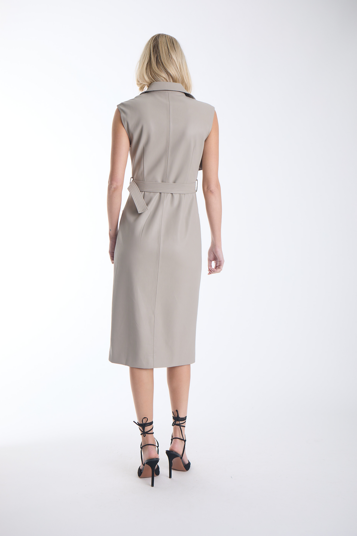 Karina Grimaldi Mila Vegan Leather Trench Dress in stone, back view on model, sleeveless with a belted waist