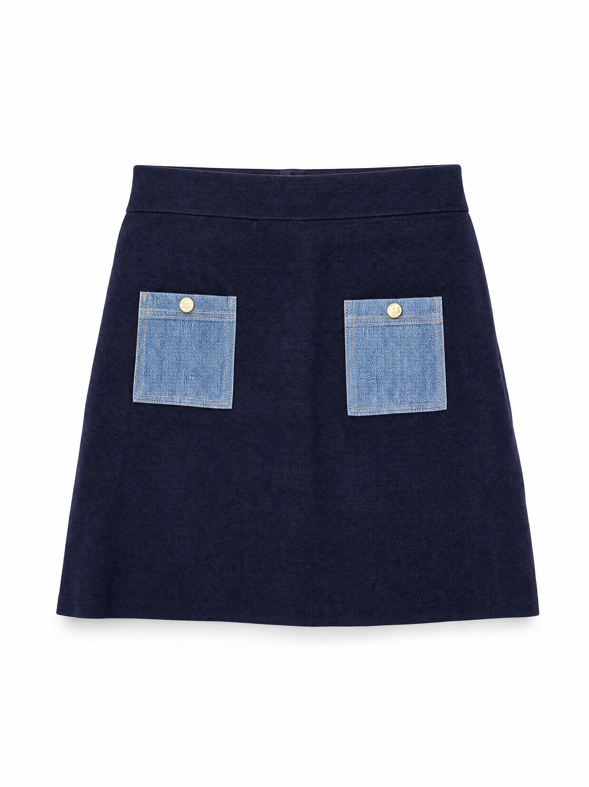 Onyx knit mini skirt in navy showing two contrast denim patch pockets with gold buttons.