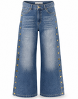 Mica wide leg jeans in denim blue showing the antique gold buttons down the outside seam, front view.