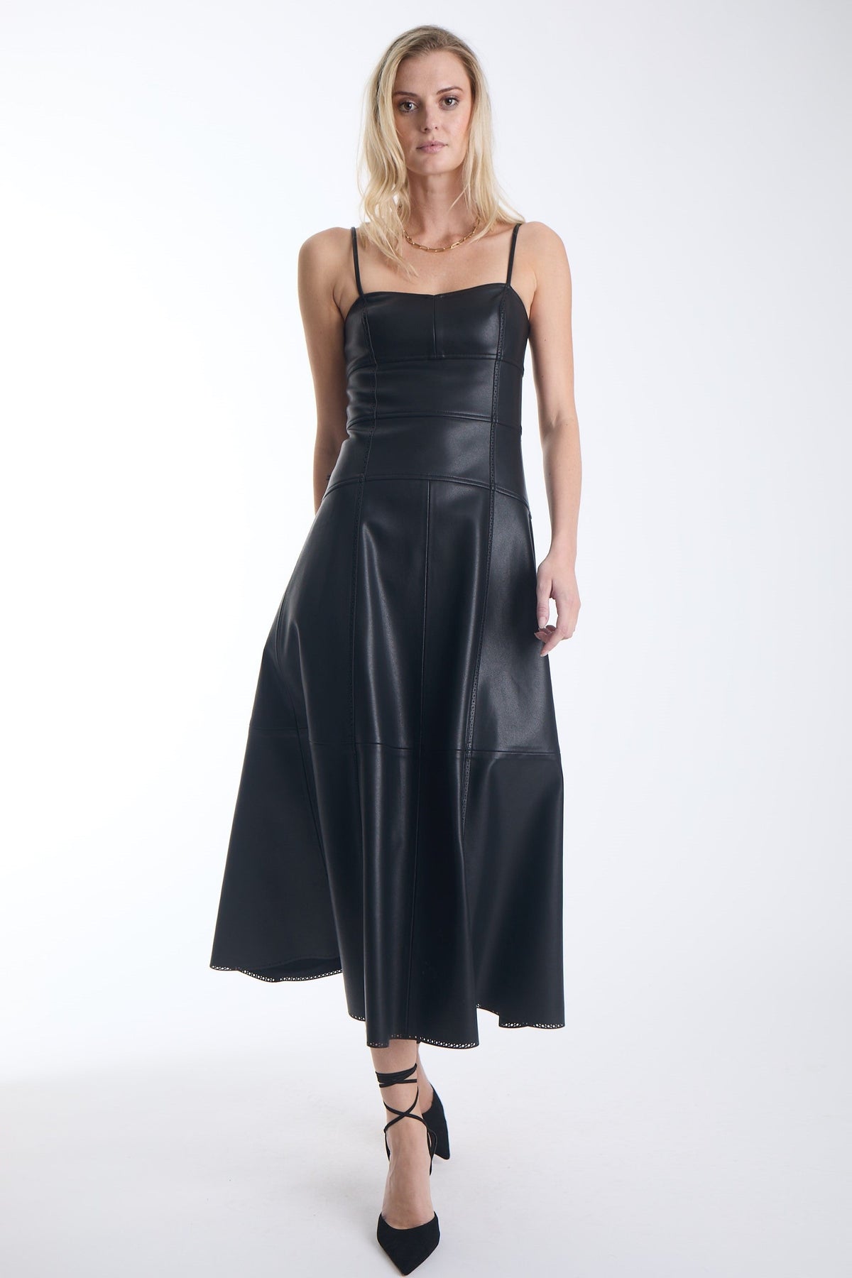 Karina Grimaldi Sofia Vegan Leather Dress in black, front view on model, spaghetti straps, sweetheart neckline and a panelled A line skirt to mid calf
