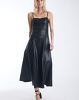 Karina Grimaldi Sofia Vegan Leather Dress in black, front view on model, spaghetti straps, sweetheart neckline and a panelled A line skirt to mid calf