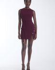 Karina Grimaldi Zarta Mini Dress in carbernet, front view on model, sleeveless with gold buttons down the side and a curved wrap hem